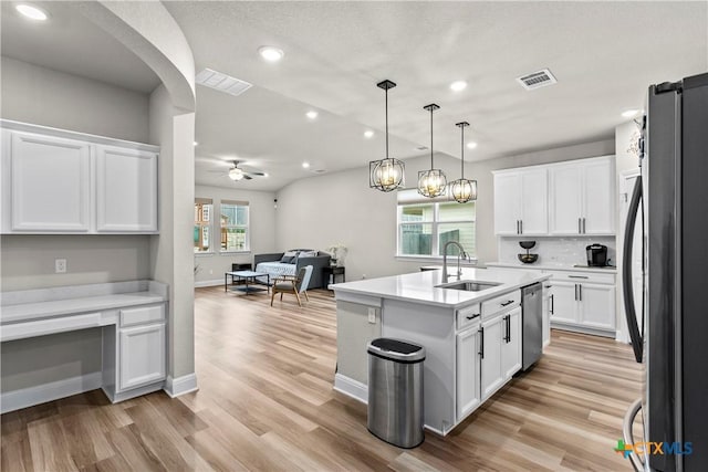 355 Victoria Peak Loop, Dripping Springs, TX 78620 - kitchen featuring appliances with stainless steel finishes, a sink, open floor plan, light countertops, and recessed lighting