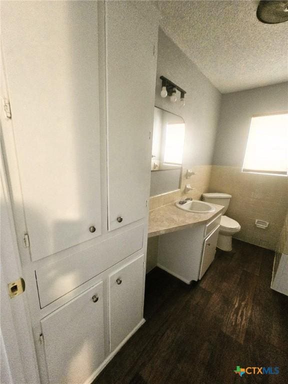 917 Edwards St, Copperas Cove, TX 76522 - bathroom with vanity, wood finished floors, healthy amount of natural light, and a textured ceiling