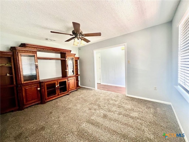 917 Edwards St, Copperas Cove, TX 76522 - unfurnished living room featuring carpet, a ceiling fan, and a textured ceiling