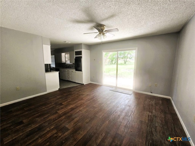 917 Edwards St, Copperas Cove, TX 76522 - unfurnished living room with dark wood-type flooring, ceiling fan, and a textured ceiling