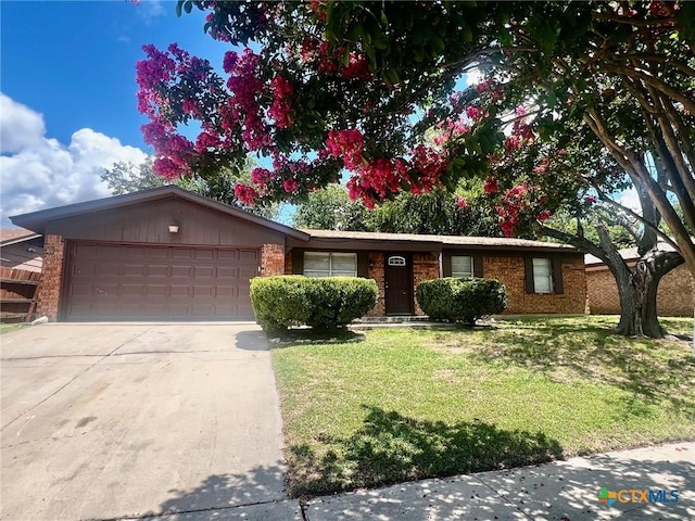 917 Edwards St, Copperas Cove, TX 76522 - ranch-style house featuring a front lawn, driveway, a garage, and brick siding