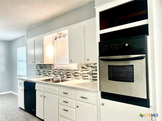 917 Edwards St, Copperas Cove, TX 76522 - kitchen featuring a textured ceiling, oven, decorative backsplash, dishwasher, and white cabinets