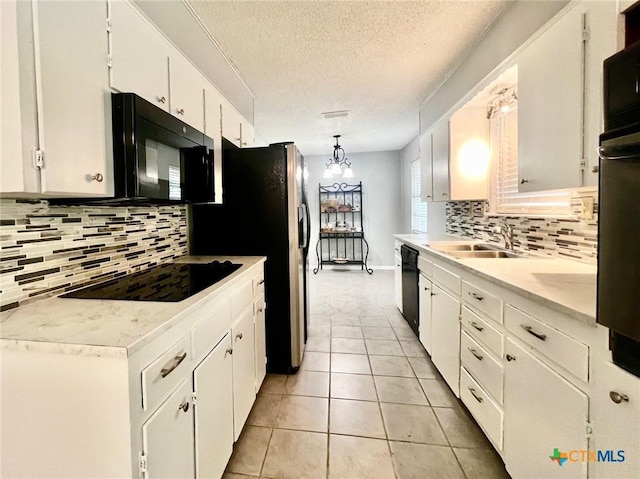 917 Edwards St, Copperas Cove, TX 76522 - kitchen with white cabinets, backsplash, black appliances, and a textured ceiling