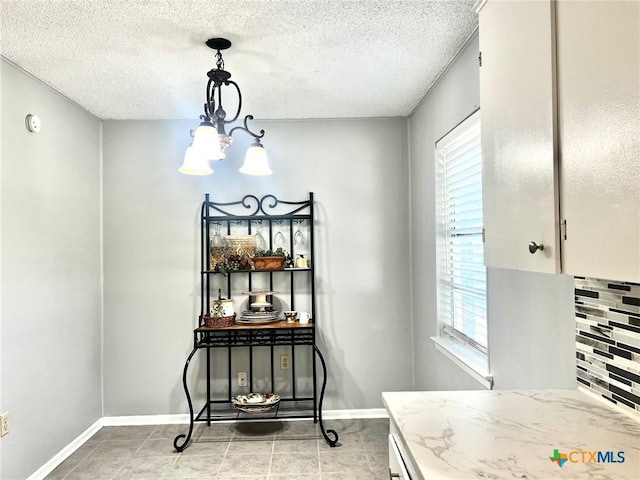 917 Edwards St, Copperas Cove, TX 76522 - dining space with plenty of natural light, a chandelier, a textured ceiling, and light tile patterned floors