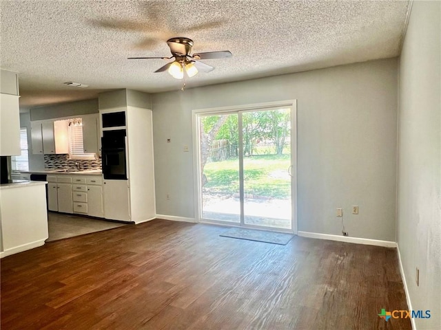 917 Edwards St, Copperas Cove, TX 76522 - unfurnished living room with ceiling fan, wood finished floors, and a textured ceiling
