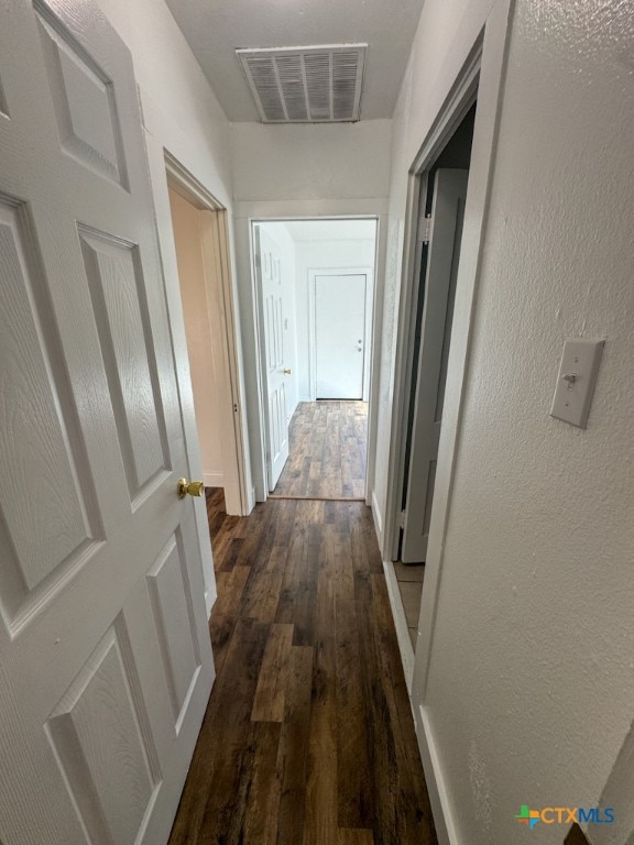 hall with dark hardwood / wood-style flooring