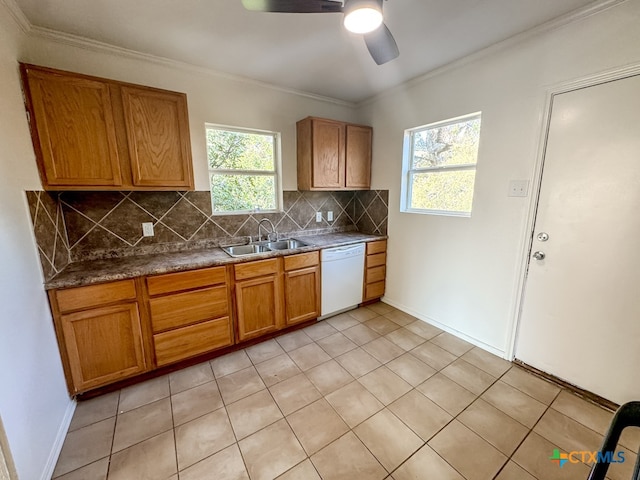 kitchen with white dishwasher, decorative backsplash, light tile patterned floors, and sink