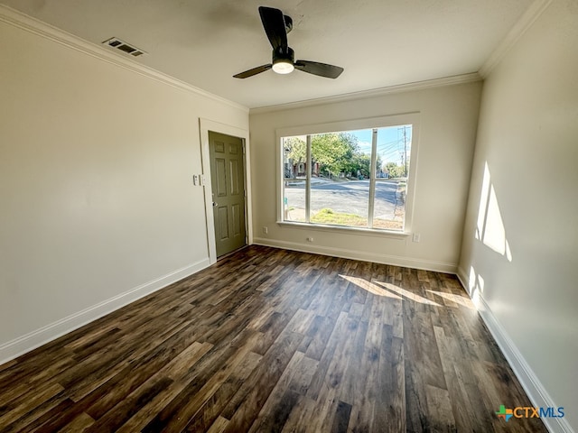 empty room featuring ceiling fan, dark wood-type flooring, and ornamental molding