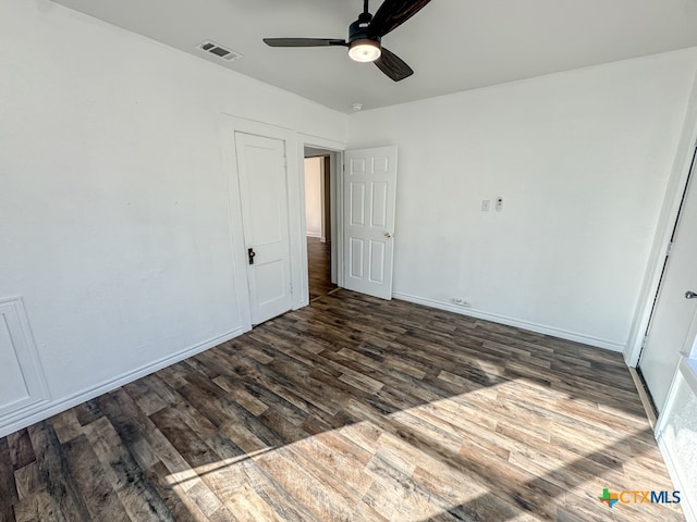 unfurnished bedroom featuring ceiling fan and dark hardwood / wood-style floors