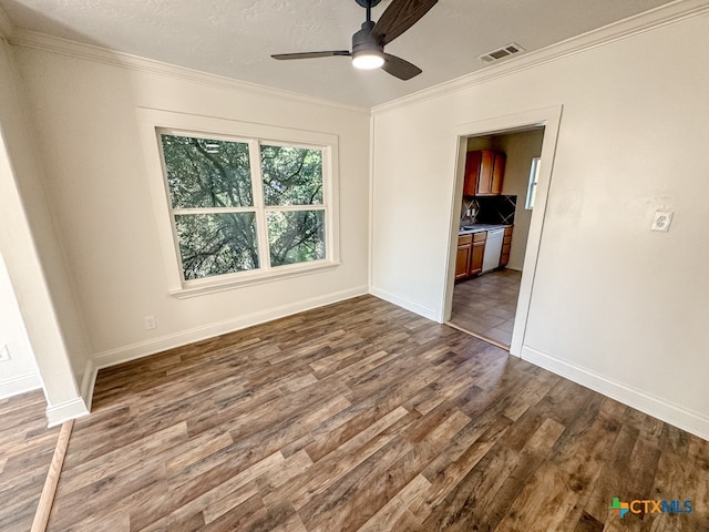 spare room with ceiling fan, hardwood / wood-style floors, a textured ceiling, and ornamental molding