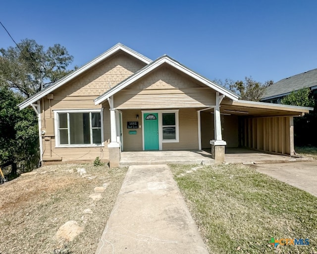 view of front facade with a porch and a carport