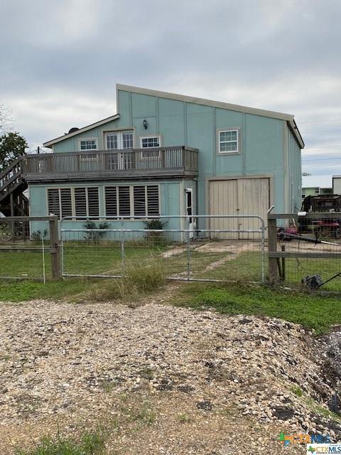 rear view of property featuring a fenced front yard