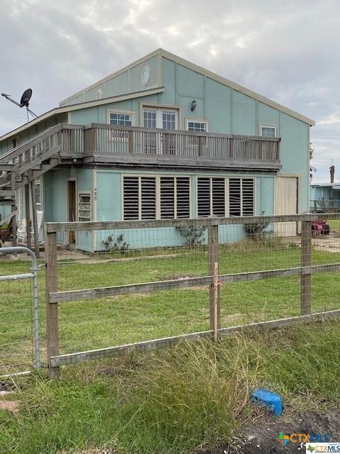 exterior space featuring fence and a lawn