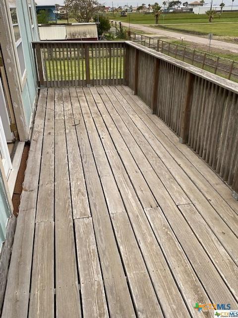 deck with a fenced backyard and a yard