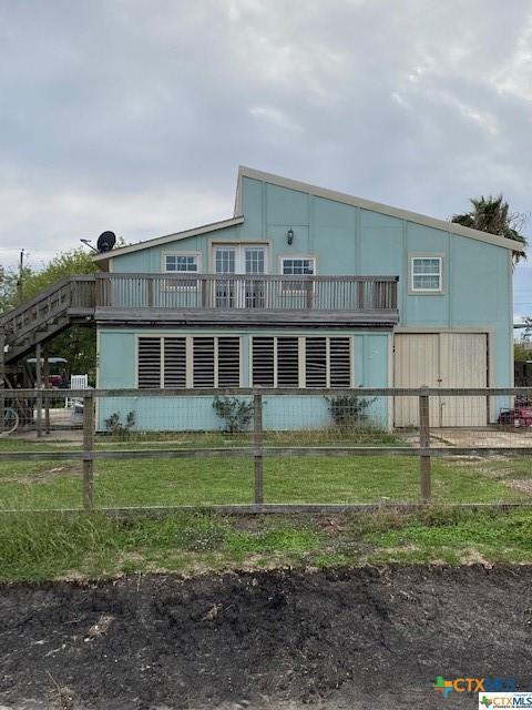 back of property featuring fence