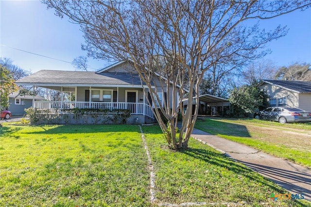 view of front of property with covered porch, a front yard, and a carport