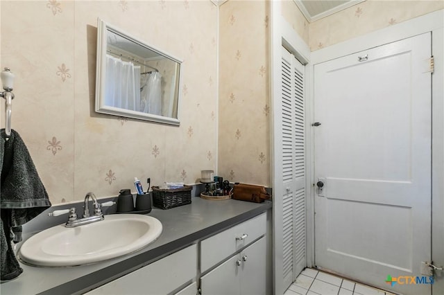 bathroom with tile patterned floors, vanity, and crown molding