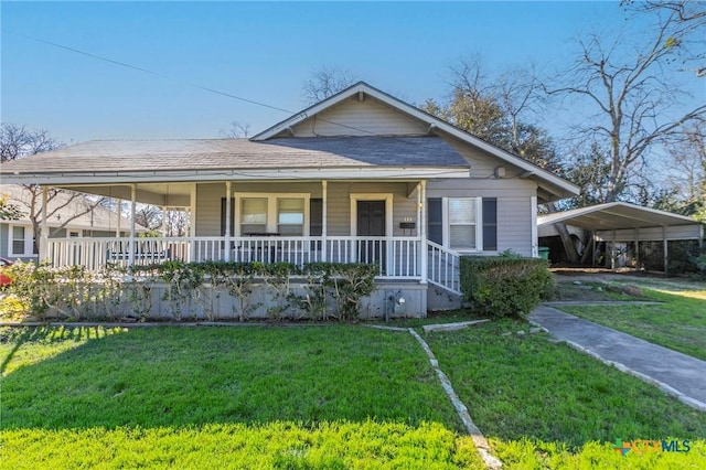 farmhouse inspired home with a carport, covered porch, and a front lawn