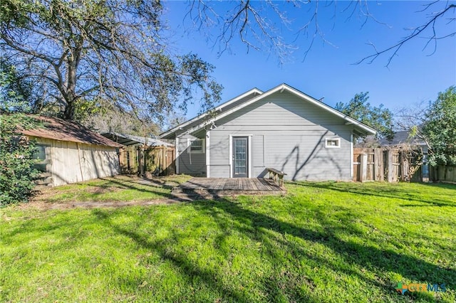 rear view of house with a patio area and a yard