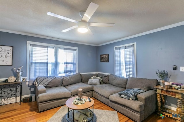 living room with ceiling fan, hardwood / wood-style flooring, and ornamental molding