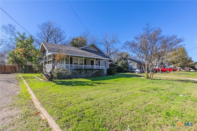 view of front of home with covered porch and a front lawn