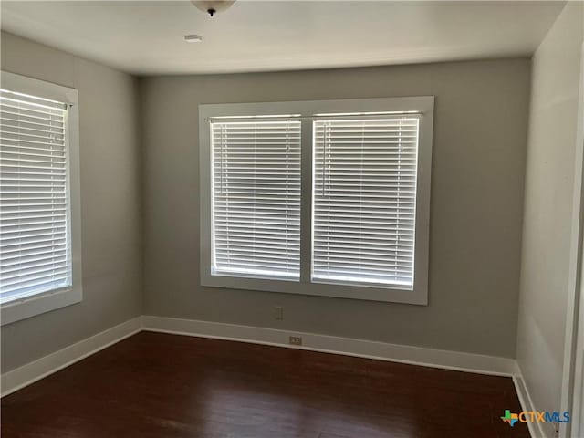 unfurnished room with dark hardwood / wood-style floors