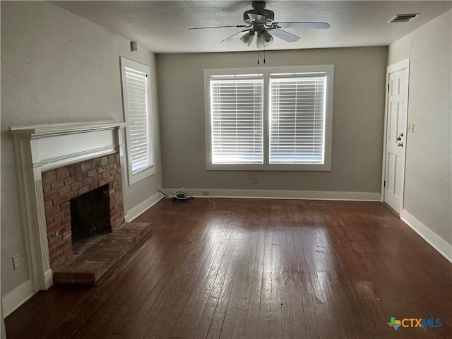 unfurnished living room with dark hardwood / wood-style flooring, a fireplace, and ceiling fan