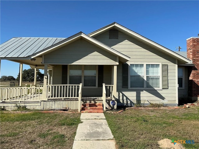 bungalow-style house with covered porch and a front yard