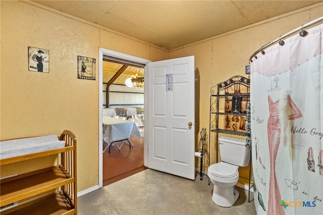 bathroom featuring concrete flooring and toilet