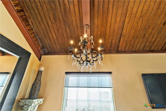 room details with ornamental molding, wood ceiling, and a notable chandelier