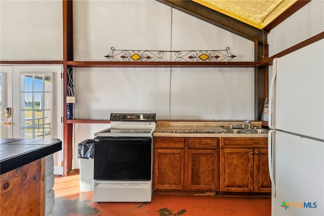 kitchen with sink, white appliances, and vaulted ceiling