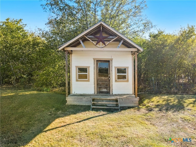 view of outdoor structure featuring a lawn