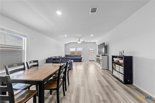 dining room with light wood-style flooring, recessed lighting, visible vents, baseboards, and vaulted ceiling