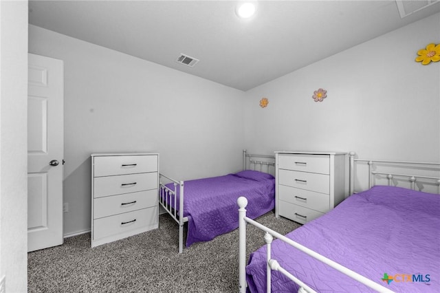 carpeted bedroom featuring visible vents