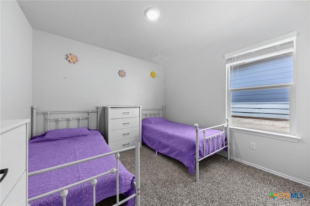 carpeted bedroom with visible vents and baseboards