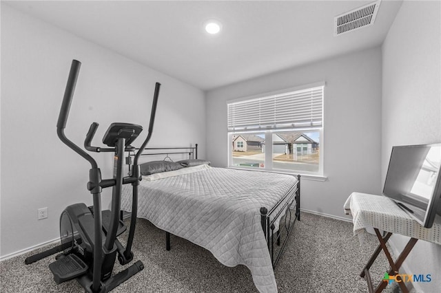 carpeted bedroom with visible vents and baseboards