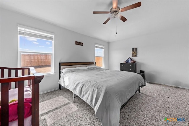 bedroom with lofted ceiling, carpet floors, ceiling fan, and baseboards