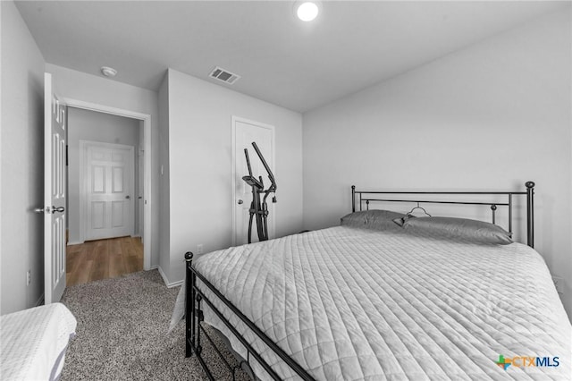 bedroom with carpet flooring, visible vents, and baseboards