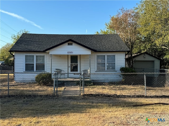 view of front of property with an outbuilding, a garage, and a front yard