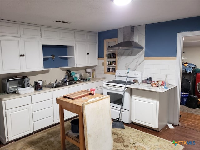 12101 Moffat Rd, Temple, TX 76502 - kitchen with white range with electric stovetop, wall chimney range hood, a sink, and light countertops