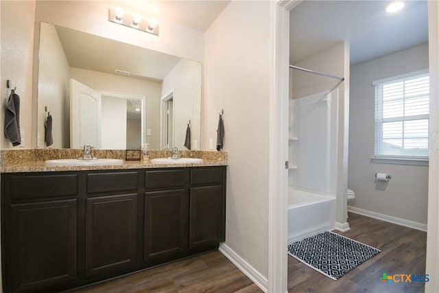 bathroom with vanity, hardwood / wood-style floors, and bathing tub / shower combination