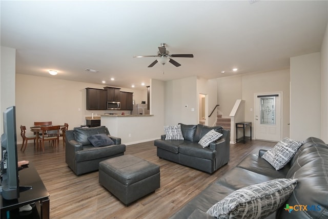 living room featuring hardwood / wood-style flooring and ceiling fan