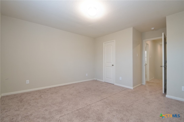 unfurnished bedroom featuring light colored carpet