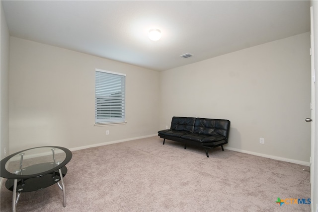 living area featuring light colored carpet