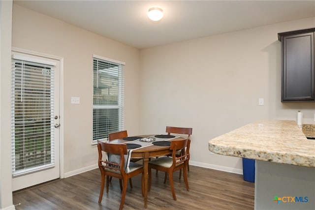 dining space with dark hardwood / wood-style floors