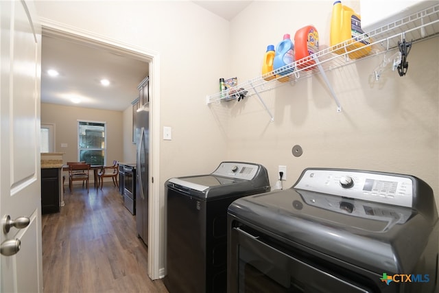 clothes washing area featuring separate washer and dryer and dark wood-type flooring