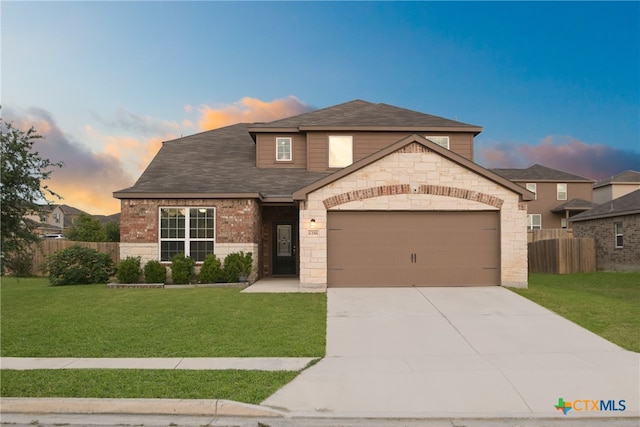 view of front of home featuring a garage and a lawn