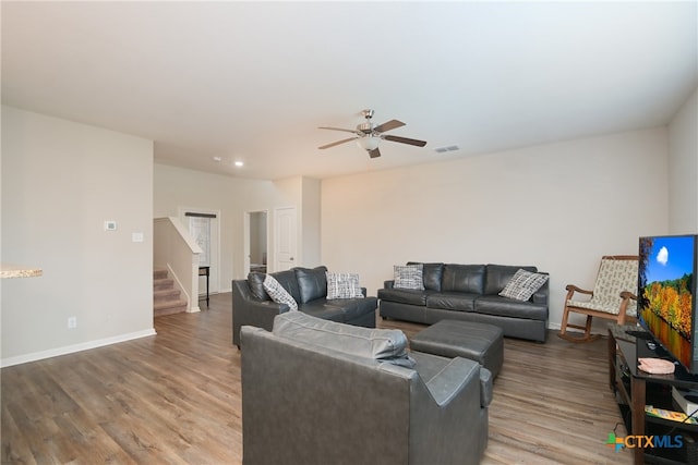 living room featuring hardwood / wood-style flooring and ceiling fan