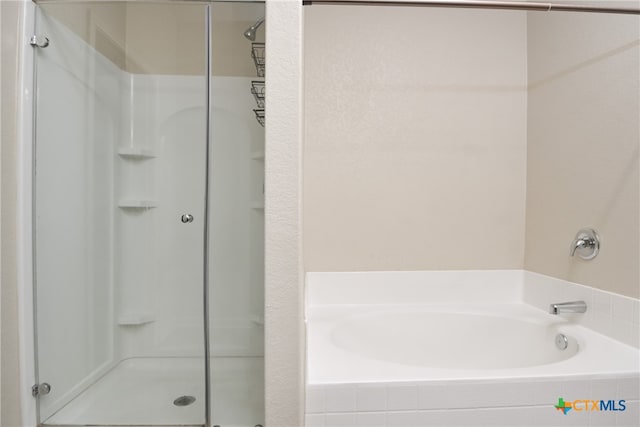 bathroom featuring separate shower and tub