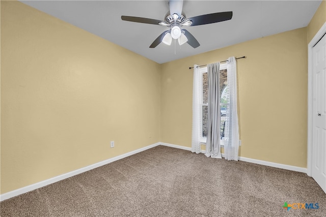 empty room featuring ceiling fan and carpet floors